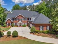 Beautiful two-story brick home with a large driveway and well-manicured landscaping at 219 Eagles Landing Way, Mcdonough, GA 30253