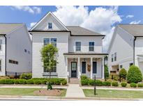 Charming two-story home featuring a welcoming front porch, manicured landscaping, and a classic design at 1023 Harvest Park Ln, Suwanee, GA 30024