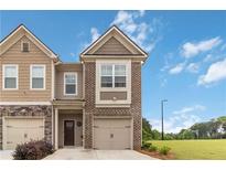 Charming two-story townhome with a brick and siding facade and a well-maintained lawn at 6315 Princeton Ridge Dr, Lithonia, GA 30058