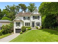 Charming two-story home featuring a manicured lawn and black shutters that add a touch of elegance to its design at 444 Rock Springs Ne Rd, Atlanta, GA 30324
