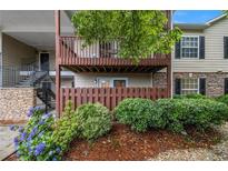 Inviting two-story condo with upper deck, stone accents, and lush landscaping at 502 Brighton Pt, Atlanta, GA 30328