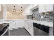 Modern kitchen featuring white cabinetry, granite countertops, and stainless steel appliances and farm sink at 502 Brighton Pt, Atlanta, GA 30328