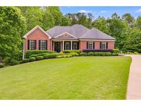 Charming one-story brick home with manicured lawn and mature trees at 7511 Biltmore Ln, Douglasville, GA 30135