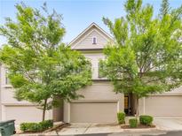 Charming townhome with well-maintained landscaping, a brick facade, and an attached two-car garage at 396 Summerhour St, Marietta, GA 30060