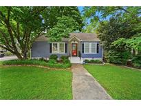 Charming blue home with a landscaped front yard and inviting red door at 511 Robinson Se Ave, Atlanta, GA 30315