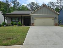 Charming one-story home with a two-car garage, manicured lawn, and inviting curb appeal at 8315 Loch Lomand Ln, Winston, GA 30187
