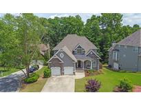 Charming two-story home boasts a well-manicured lawn and a convenient two-car garage at 5755 Vinings Place Se Ct, Mableton, GA 30126