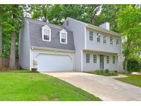 Charming two-story home featuring a two-car garage, gray siding, and meticulously maintained front lawn at 1160 Haven Brook Ne Way, Brookhaven, GA 30319
