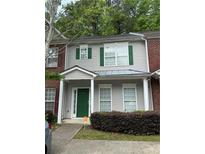 Charming townhouse with gray siding, green shutters, and a well-maintained front yard at 20 Pine Canyon Sw Dr # 26, Atlanta, GA 30331