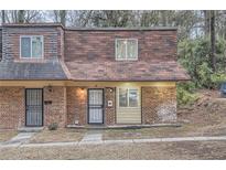 Charming townhome with brick facade and well-maintained landscaping at 11 Peyton Place Sw, Atlanta, GA 30311