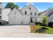 Charming two-story home boasts a welcoming front porch, a well-manicured lawn, and a two car garage at 139 Treeline Trl, Canton, GA 30115