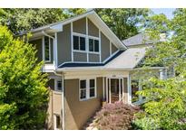 Charming two-story home with a brick and taupe facade, complemented by lush green landscaping at 608 Sherwood Ne Rd, Atlanta, GA 30324