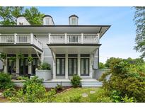 Charming two-story home with a balcony and beautifully landscaped front yard and gray siding at 364 Glendale Ne Ave # B, Atlanta, GA 30307