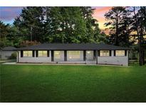 Charming single-story home with a well-manicured lawn and classic architectural design at 2604 Flat Shoals Sw Rd, Conyers, GA 30094