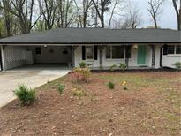 Charming single-story home with fresh exterior paint, manicured landscaping, and a covered carport at 4103 Laynewood, Tucker, GA 30084