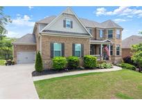 Stately brick home with a well-manicured lawn and attached two car garage at 4388 Cades Pointe, Marietta, GA 30066