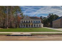 Beautiful two-story home featuring a landscaped front yard and a classic architectural style at 76 Homesite Dulles Dr, Mcdonough, GA 30253