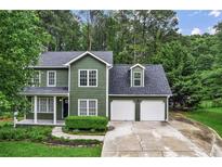 Charming two-story home with a well-manicured lawn and two-car garage at 1320 Country Acres Ln, Lawrenceville, GA 30045