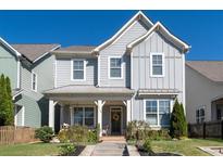 Charming two-story home with a welcoming front porch, manicured lawn and tasteful landscaping at 2100 Drew Nw Dr, Atlanta, GA 30318