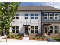 Charming townhome with neutral siding, brick accents, well-manicured landscaping, and dark door frames at 339 Skylar Se Way, Atlanta, GA 30315