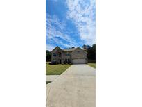 Beautiful two-story brick home with a well-manicured lawn and attached two-car garage at 5010 Lynnonhall Ct, Stonecrest, GA 30038