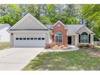 Charming single-Gathering home featuring a two-car garage and landscaped front yard at 2175 Charleston Oak Cir, Lawrenceville, GA 30043