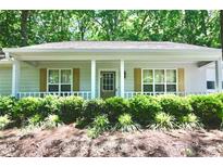 Charming home featuring a welcoming front porch, a landscaped yard, and a well-maintained exterior at 3436 Finglas Dr, Marietta, GA 30008