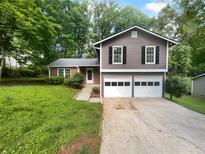 Charming two-story home with a two-car garage and freshly painted exterior at 4504 Cedar Ridge Trl, Stone Mountain, GA 30083