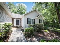 Charming single-story home with neutral siding, black shutters, and a stone accent entryway at 239 Clear Brook Trl, Douglasville, GA 30134