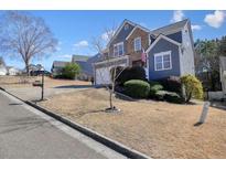 Charming two-story home with a well-manicured lawn and inviting curb appeal in a suburban neighborhood at 537 Autumn Ridge Dr, Canton, GA 30115