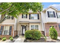 Charming townhome showcasing brick accents, neutral siding, black shutters, and a well-manicured front yard at 7244 Rockhouse Rd, Austell, GA 30168