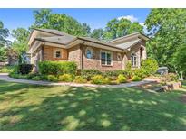 Lovely brick home featuring pristine landscaping and a well-maintained lawn at 5816 Chamblee Dunwoody Rd, Atlanta, GA 30338
