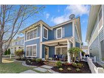 Charming two-story home with blue siding, covered porch, and professionally landscaped front yard at 1338 Dupont Nw Park, Atlanta, GA 30318