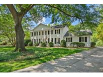 Stately white home featuring classic columns, manicured landscaping, and mature trees at 2580 Hyde Manor Dr, Atlanta, GA 30327