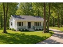Charming single-story home featuring a cozy front porch with green railings and a well-manicured lawn at 6032 Lakeshore Se Dr, Mableton, GA 30126