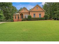 Beautiful brick home with manicured lawn and mature trees in a desirable neighborhood at 7940 Gable Dr, Douglasville, GA 30135