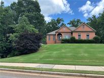 Charming brick home featuring a beautifully landscaped yard and inviting entrance at 7940 Gable Dr, Douglasville, GA 30135