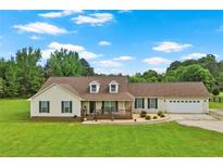 Charming ranch-style home featuring a welcoming front porch and an attached two-car garage with a well-manicured front lawn at 24 Fossetts Nw Cv, Cartersville, GA 30121