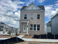 Beautiful two-story home with brick exterior and covered front porch and walkway at 2733 Creek View Nw Ter, Atlanta, GA 30318