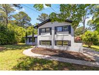 Charming home with painted brick, black shutters, landscaping, and inviting walkway at 2158 Oregon Ct, Decatur, GA 30032