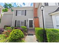 Charming two-story townhouse featuring a brick accent, well-maintained landscaping and a cozy front entrance at 62 Mount Vernon Cir, Atlanta, GA 30338