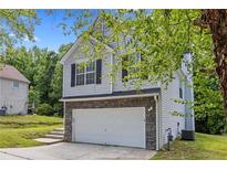 Charming two-story home featuring a two-car garage and traditional curb appeal at 9511 Rollinghills Dr, Jonesboro, GA 30238