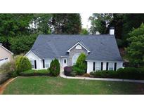 Charming single-story home with stone accents, manicured lawn, and mature trees adding curb appeal at 260 Ruby Forest Pkwy, Suwanee, GA 30024
