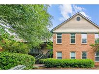Charming brick exterior featuring a two-story design, surrounded by lush greenery and mature trees at 721 Beaufort Cir, Duluth, GA 30096