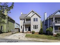 Charming two-story home featuring a classic design, well-maintained lawn, and inviting curb appeal on a sunny day at 78 Crumley Se St, Atlanta, GA 30312