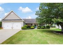 Charming home with a well-manicured lawn, beautiful landscaping, and an attached two car garage at 102 Autumn Brooke Trl, Dallas, GA 30157