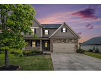 Charming two-story home with a stone facade, two-car garage, and well-manicured lawn at twilight at 13 Cottage Nw Walk, Cartersville, GA 30121