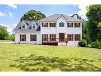 Charming two-story home featuring a white exterior, wood shutters, and a well-maintained front lawn at 17 Hiram Way, Hiram, GA 30141