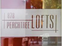 View of the '878 Peachtree Lofts' signage displayed on a window at 878 Peachtree Ne St # 431, Atlanta, GA 30309