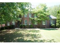Charming brick home with manicured lawn and mature trees, offering a welcoming curb appeal at 3235 Munsey Ct, Cumming, GA 30041
